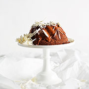 Nutty wheat, sweet potato, orange and dark chocolate Bundt Cake With Milk Chocolate Ganache and White Chocolate Shavings