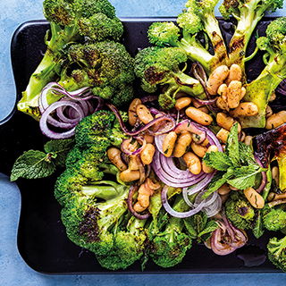 Grilled broccoli steaks with white beans, red onions and anchovy butter